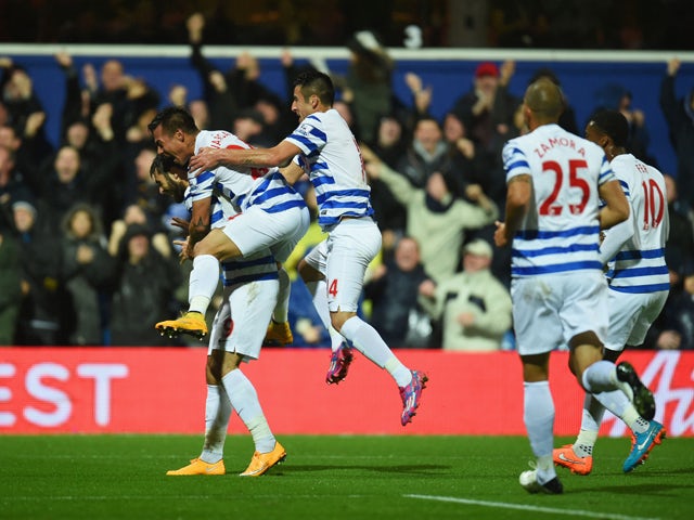 Charlie Austin of QPR celebrates with team mates as he scores their first goal during the Barclays Premier League match between Queens Park Rangers and Manchester City at Loftus Road on November 8, 2014