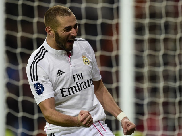 Real Madrid's French forward Karim Benzema celebrates after scoring a goal during the UEFA Champions League group B football match Real Madrid CF vs Liverpool FC at the Santiago Bernabeu stadium in Madrid on November 4, 2014