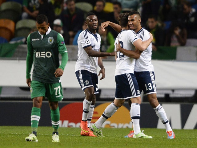 Schalke's Cameroonian forward Eric Maxim Choupo-Moting celebrates with his teammates after scoring during the UEFA Champions League football match Sporting Clube de Portugal vs FC Schalke 04 at the Jose Alvalade stadium in Lisbon on November 5, 2014.