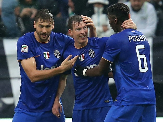 Juventus' Stephan Lichtsteiner celebrates after scoring with Fernando Llorente and Paul Pogba on November 9, 2014