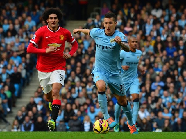 Stevan Jovetic is chased by Marouane Fellaini during the Manchester derby on November 2, 2014