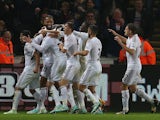 Swansea players celebrate after Swansea City's Icelandic midfielder Gylfi Sigurdsson (3L) scored an equalising goal during the English Premier League football match against Arsenal on November 9, 2014