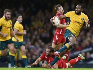 Tevita Kuidrani (R) of Australia breaks through the challenge of Jamie Roberts of Wales to score his sides third try during the International match on November 8, 2014