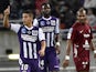 Toulouse's French Tunisian forward Wissam Ben Yedder celebrates after scoring a goal as Metz' French midfielder Florent Malouda looks on during the French L1 football match Toulouse vs Metz on November 8, 2014