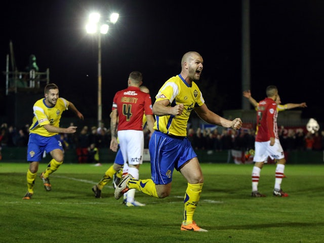 Craig Robinson of Warrington Town celebrates the opening goal during the FA Cup First Round match between Warrington Town and Exeter City at Cantilever Park on November 7, 2014