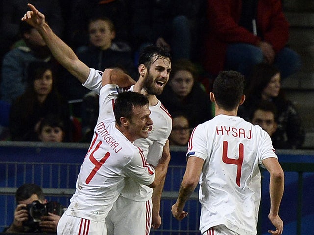 Albania's defender Mergim Mavraj is congratuled by teammates after scoring a goal during during the friendly football match France vs Albania on November 14, 2014