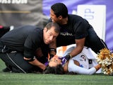 A Ravens cheerleader is tended to after falling during a game between the Baltimore Ravens and Tennessee Titans at M&T Bank Stadium on November 9, 2014