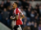 Andre Gray of Brentford celebrates after scoring to make it 2-1 during the Sky Bet Championship match between Millwall and Brentford at The Den on November 8, 2014