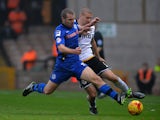 Carl Dickinson of Port Vale is tackled by Stephen Dawson of Rochdale during the Sky Bet League One match between Port Vale and Rochdale at Vale Park on November 15, 2014