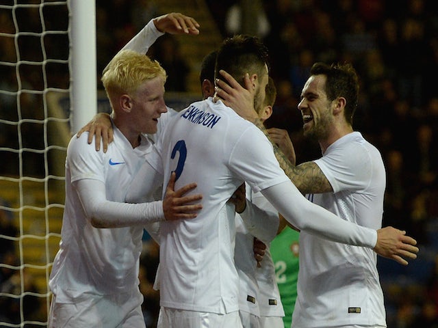 Carl Jenkinson of England celebrates scoring his team's second goal with Will Hughes and Danny Ings during the U21 International Friendly match against Portugal on November 13, 2014