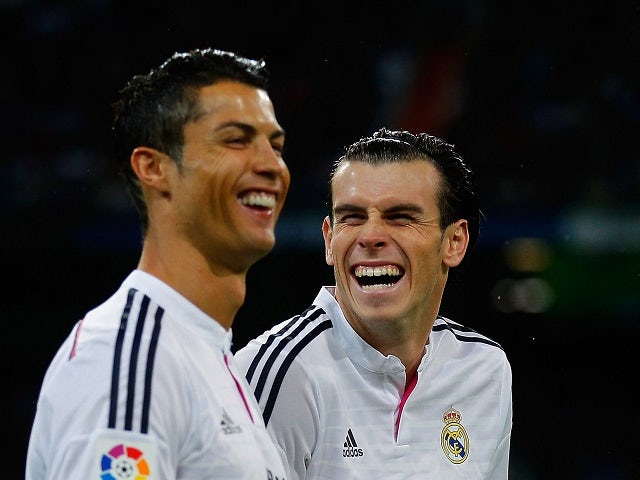 Cristiano Ronaldo (L) of Real Madrid jokes with his teammate Gareth Bale prior to start the La Liga match against Rayo Vallecano on November 8, 2014