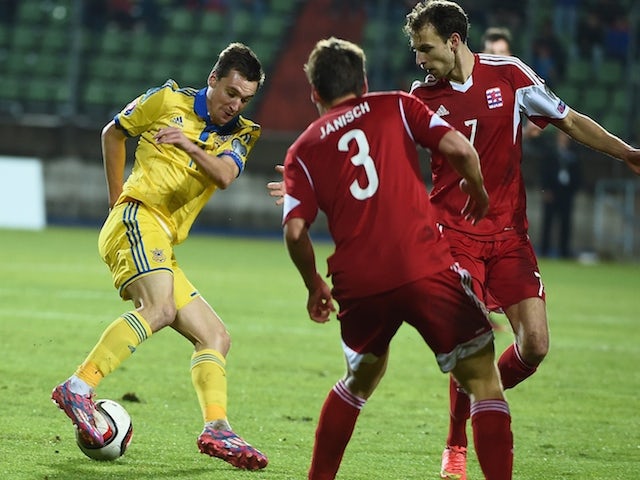 Ukraine's Denys Oliynyk vies with Luxembourg's Mathias Janisch (C) and Lars Gerson during the Group C Euro 2016 qualifying football match on November 15, 2014