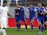 Faroe Island's Joan Edmundsson celebrates with his teammates after scoring a goal during the UEFA Euro 2016 group F qualifying football match between Greece and Faroe Island at the Karaiskaki stadium in Piraeus, near Athens, on November 14, 2014