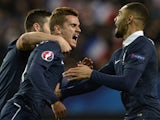French forward Antoine Griezmann is congratulated by teammates after scoring during the friendly football match France vs Albania on November 14, 2014