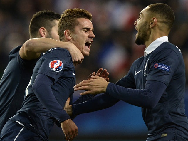 French forward Antoine Griezmann is congratulated by teammates after scoring during the friendly football match France vs Albania on November 14, 2014