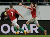 Hungary's midfielder Zoltán Gera celebrates scoring a goal with Hungary's midfielder Balazs Dzsudzsak (L) during the UEFA 2016 European Championship qualifying round Group F football match Hungary vs Finland at the Groupama Arena stadium in Budapest on