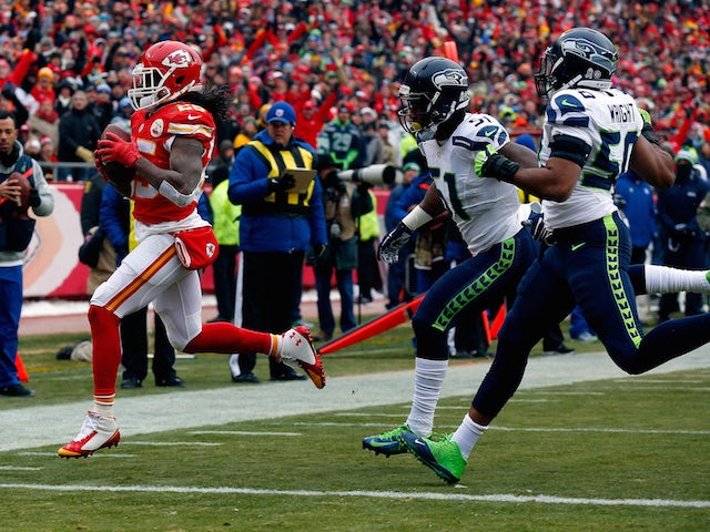 Jamaal Charles #25 of the Kansas City Chiefs scores a touchdown against Bruce Irvin #51 and K.J. Wright #50 of the Seattle Seahawks on November 16, 2014