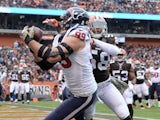 J.J. Watt #99 of the Houston Texans makes a touchdown catch in front of Chris Kirksey #58 of the Cleveland Browns on November 16, 2014