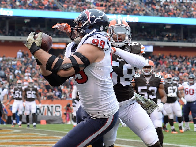 J.J. Watt #99 of the Houston Texans makes a touchdown catch in front of Chris Kirksey #58 of the Cleveland Browns on November 16, 2014