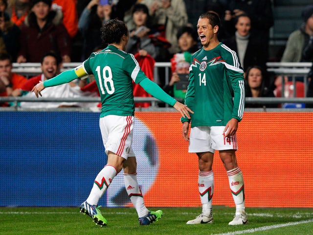 Javier Hernandez #14 of Mexico is congratulated by team mates after scoring the third goal of the game for his team during the international friendly match between Netherlands and Mexico held at the Amsterdam ArenA on November 12, 2014