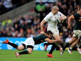 Mike Brown of England is tackled by Cobus Reinach of South Africa during the QBE Intenational match on November 15, 2014