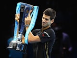 Novak Djokovic of Serbia poses with the ATP trophy on day eight of the Barclays ATP World Tour Finals at O2 Arena on November 16, 2014