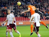 Dutch player Robin Van Persie (C) jumps to score a goal during the Euro 2016 qualifying round football match between Netherlands and Latvia at the Arena Stadium, on November 16, 2014