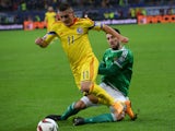 Romania's midfielder Gabriel Torje and Northern Ireland's defender Connor McLaughlin vie for the ball during the UEFA 2016 European Championship qualifying round Group F football match Romania vs Northern Ireland at the Arena Nationala stadium in Buchares
