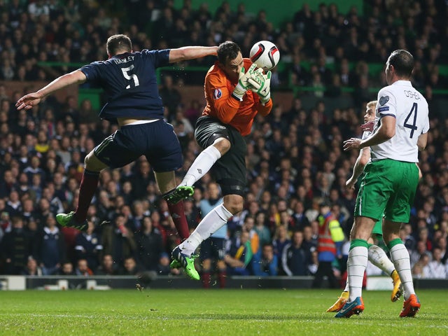 Scotland's defender Grant Hanley vies with Republic of Ireland's goalkeeper David Forde during the Euro 2016 Qualifier, Group D football match between Scotland and Republic of Ireland at Celtic Park in Glasgow, Scotland on November 14, 2014