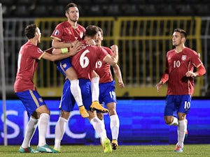 Serbia's striker Zoran Tosic celebrates with teammates after scoring a goal during the EURO 2016 group I football match between Serbia and Denmark in Belgrade on November 14, 2014