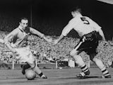 Blackpool's forward Stanley Matthews dribbles past Bolton's midfielder Barass during the English Cup final 03 May 1953 