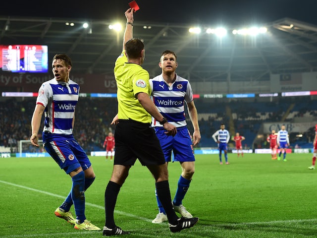 Reading player Alex Pearce (r) is sent off by referee James Linington as Chris Gunter (l) reacts during the Sky Bet Championship match against Cardiff City on November 21, 2014
