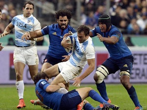 Argentina's centre Juan Martín Hernández is tackled by France's wing Yoann Huget and France's captain Thierry Dusautoir during the international rugby test match France vs Argentina on November 22, 2014