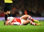 Jack Wilshere of Arsenal lies injured after a tackle during the Barclays Premier League match between Arsenal and Manchester United at Emirates Stadium on November 22, 2014