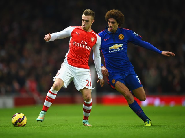 Calum Chambers of Arsenal and battle for the ball Marouane Fellaini of Manchester United during the Barclays Premier League match between Arsenal and Manchester United at Emirates Stadium on November 22, 2014