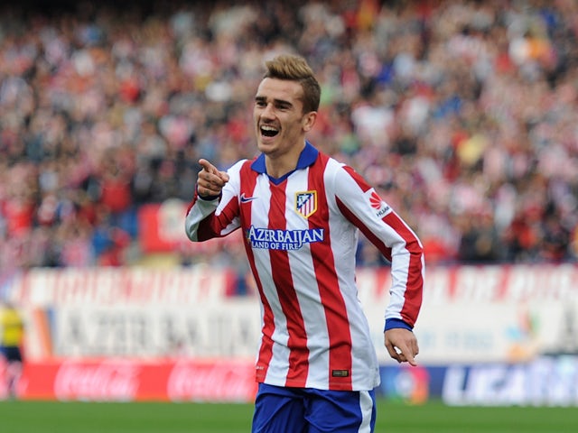 Antoine Griezmann of Club Atletico de Madrid celebrates after scoring his team's 2nd goal during the La Liga match between Club Atletico de Madrid and Malaga CF at Vicente Calderon Stadium on November 22, 2014