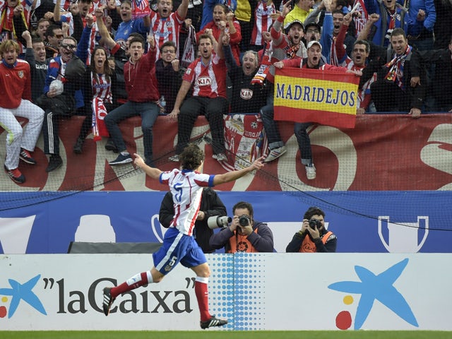 Atletico Madrid's Portuguese midfielder Tiago celebrates after scoring during the Spanish league football match Club Atletico de Madrid vs Malaga CF at the Vicente Calderon stadium in Madrid on November 22, 2014