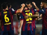 Lionel Messi of FC Barcelona celebrates with his teammates after scoring the opening goal during the La Liga mach between FC Barcelona and Sevilla FC at Camp Nou on November 22, 2014