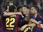 Barcelona's Argentinian forward Lionel Messi celebrates with his teammates after setting a new La Liga goalscoring record during the Spanish league football match FC Barcelona vs Sevilla FC at the Camp Nou stadium in Barcelona on November 22, 2014