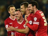 Cardiff player Ben Turner (2nd r) celebrates with team mates after Reading player Alex Pearce had put into his own net for the opening goal on November 21, 2014