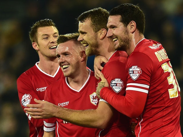 Cardiff player Ben Turner (2nd r) celebrates with team mates after Reading player Alex Pearce had put into his own net for the opening goal on November 21, 2014