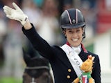 Gold medalist British Charlotte Dujardin celebrates on the podium on August 29, 2014 during the medal ceremony of the Individual Freestyle Dressage Grand Prix of the 2014 FEI World Equestrian Games