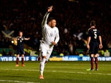 Alex Oxlade-Chamberlain of England celebrates after scoring the opening goal during the International Friendly match between Scotland and England at Celtic Park Stadium on November 18, 2014