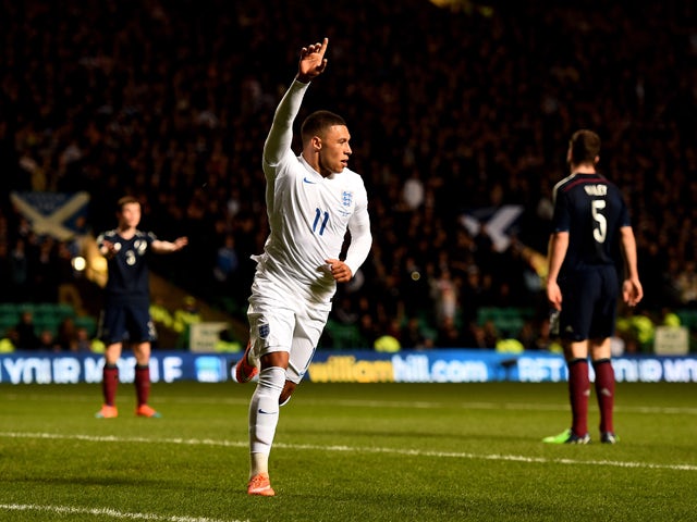 Alex Oxlade-Chamberlain of England celebrates after scoring the opening goal during the International Friendly match between Scotland and England at Celtic Park Stadium on November 18, 2014