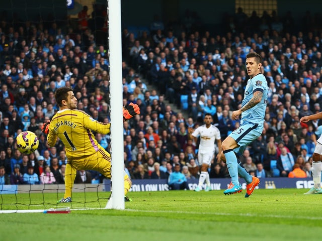 Stevan Jovetic of Manchester City scores his goal during the Barclays Premier League match between Manchester City and Swansea City at Etihad Stadium on November 22, 2014