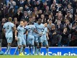 Manchester City's Ivorian midfielder Yaya Toure celebrates with teammates after scoring his team's second goal during the English Premier League football match between Manchester City and Swansea City at the The Etihad Stadium in Manchester, north west En