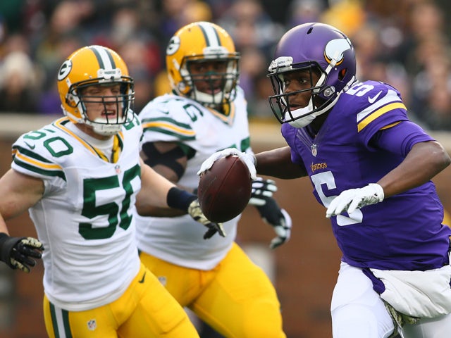 Teddy Bridgewater #5 of the Minnesota Vikings avoids the defense in the first quarter against the Green Bay Packers on November 23, 2014