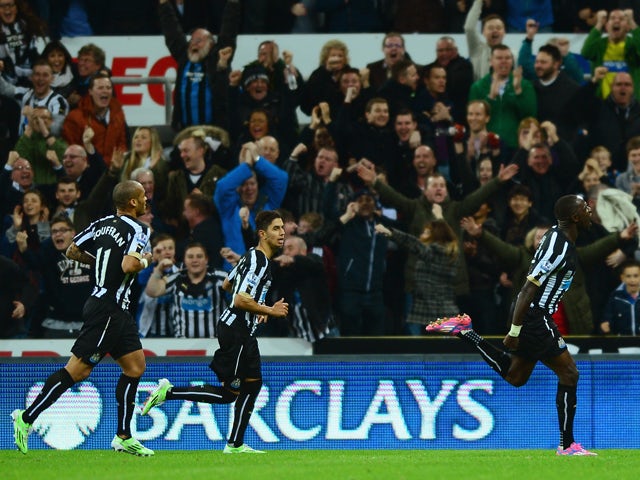 Moussa Sissoko of Newcastle United celebrates scoring the opening goal with team mates during the Barclays Premier League match between Newcastle United and Queens Park Rangers at St James' Park on November 22, 2014