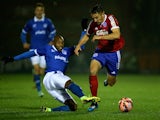 Nigel Atangana of Portsmouth tackles Brett Williams of Aldershot during the FA Cup First Round Replay match on November 19, 2014