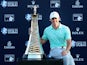 Rory McIlroy of Northern Ireland poses with the Race To Dubai trophy after winnng The Race To Dubai at the DP World Tour Championship at Jumeirah Golf Estates on November 23, 2014
